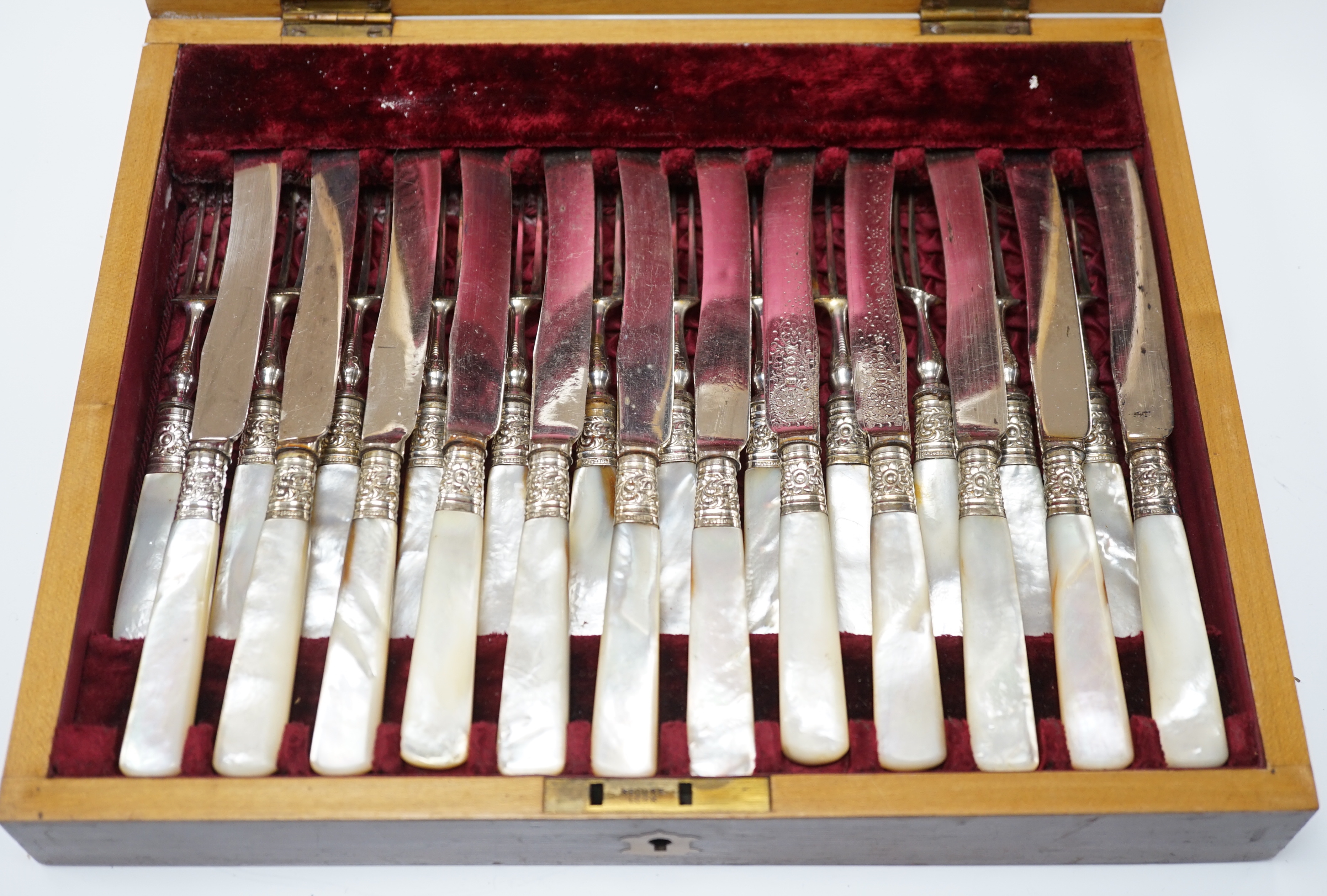 Six pairs of George V mother of pearl handled silver dessert eaters, Elkington & Co, Birmingham, 1912 and a cased set of twelve pairs of mother of pearl handled silver plated dessert eaters.